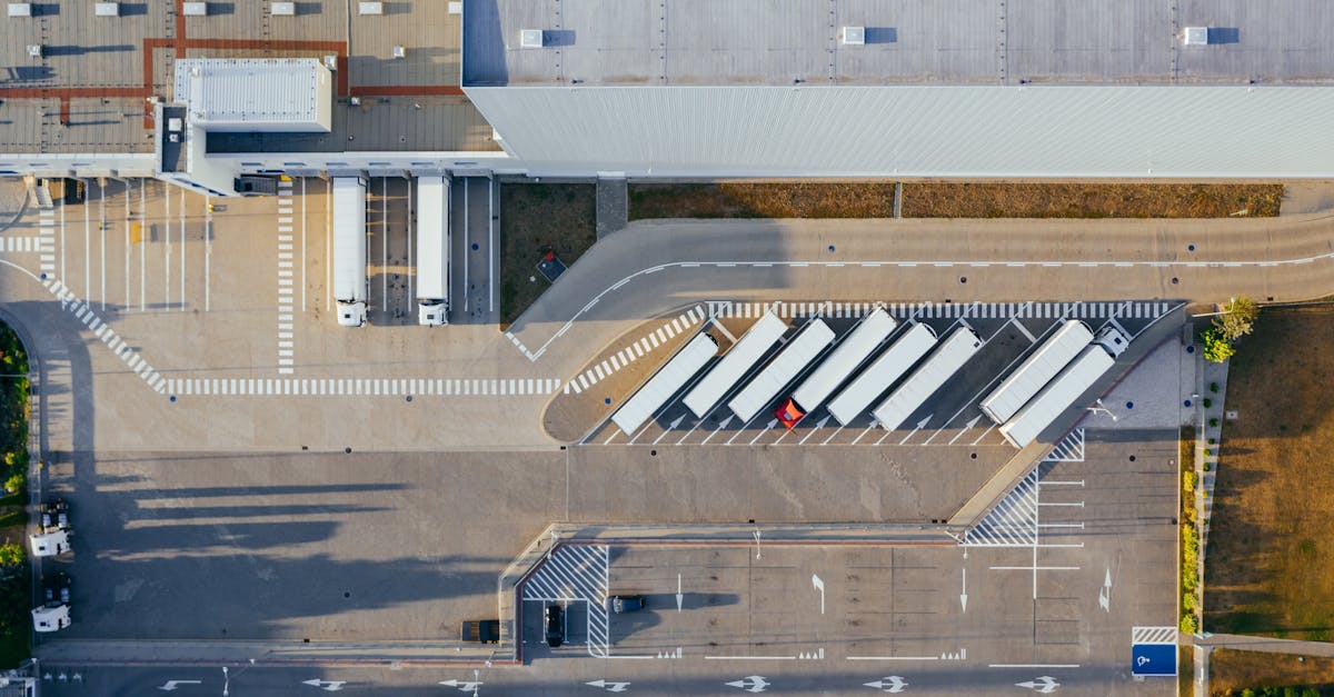 Drone shot of a logistics center with trucks and parking lot in Poznań, Poland.